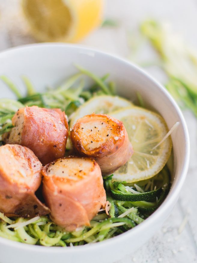 Prosciutto Wrapped scallops served on Basil Parmesan Zoodles, this dish is light and fresh, and is full of flavor! 