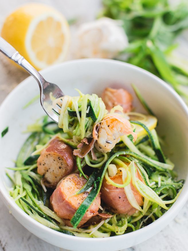 Prosciutto Wrapped scallops served on Basil Parmesan Zoodles, this dish is light and fresh, and is full of flavor! 