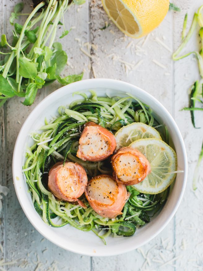 Prosciutto Wrapped scallops served on Basil Parmesan Zoodles, this dish is light and fresh, and is full of flavor! 