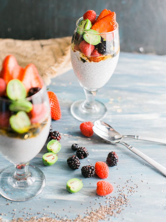 Chia parfait with a chia pudding and vanilla greek yogurt. Topped with honey, baby kiwis, and other fresh fruits. Makes a great quick and healthy breakfast!