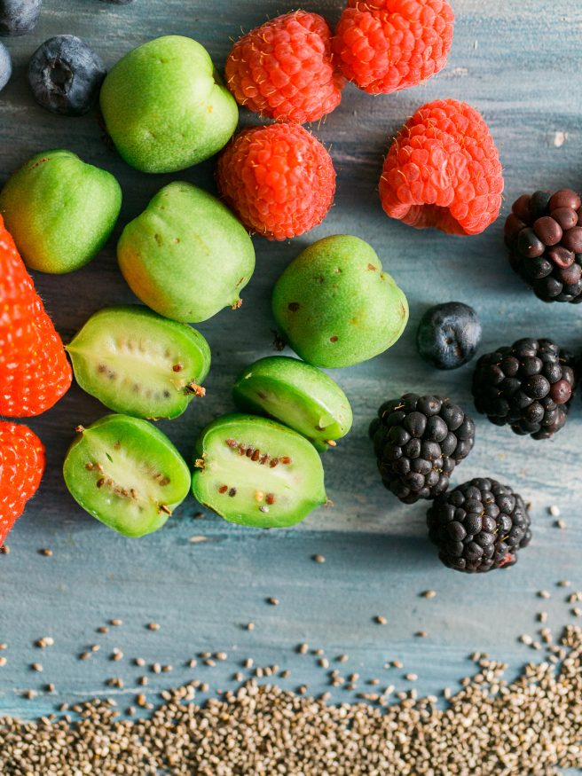 Chia parfait with a chia pudding and vanilla greek yogurt. Topped with honey, baby kiwis, and other fresh fruits. Makes a great quick and healthy breakfast!