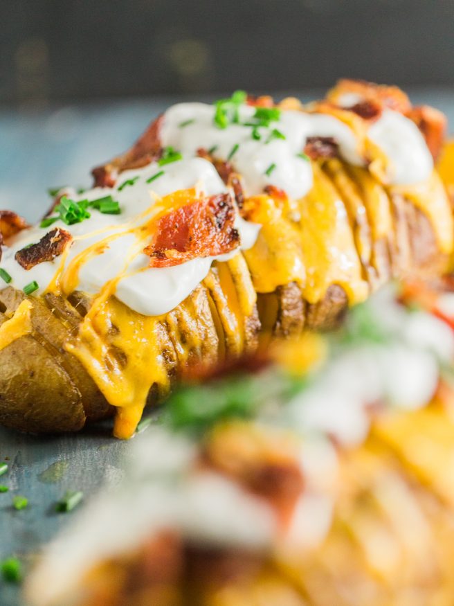 Hasselback potatoes loaded with cheese, bacon, sour cream, and fresh chopped chives, this is my new favorite way to have a baked potato!