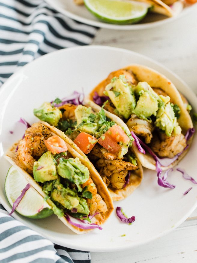 Spicy Shrimp Tacos cooked on the grill, with chili powder, red pepper flakes, cayenne pepper, and other spices. Perfect for the summer!