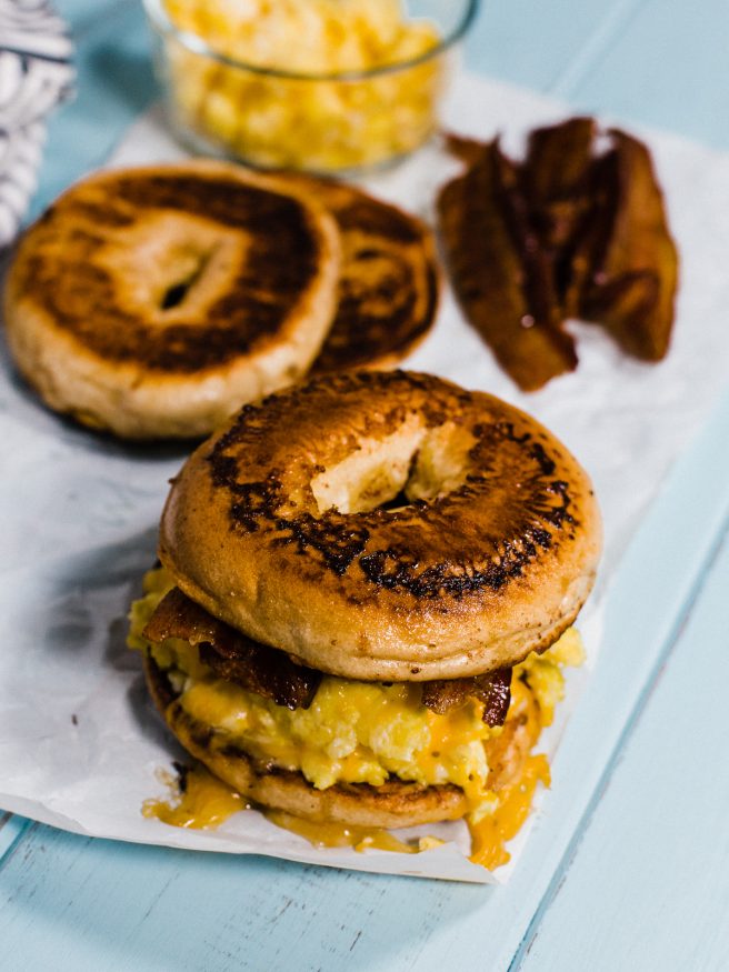 French Toast Bagel topped with eggs, cheese and smokey bacon, making for a sweet and savory breakfast sandwich everyone is going to love! 