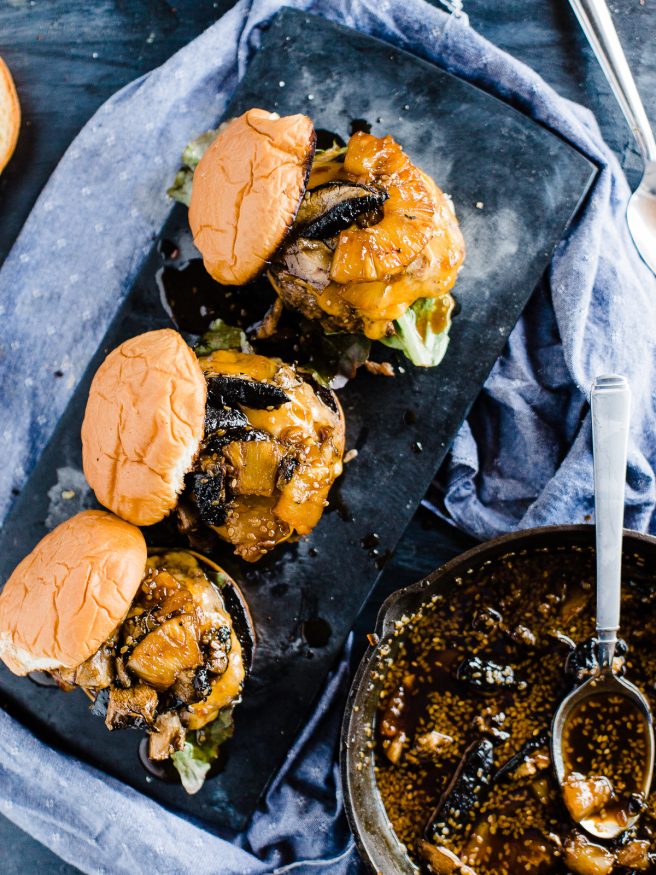 Teriyaki Burger topped with a Grilled pineapple, portabella mushroom, simmering in teriyaki sauce and topped on toasted Hawaiian hamburger rolls. 