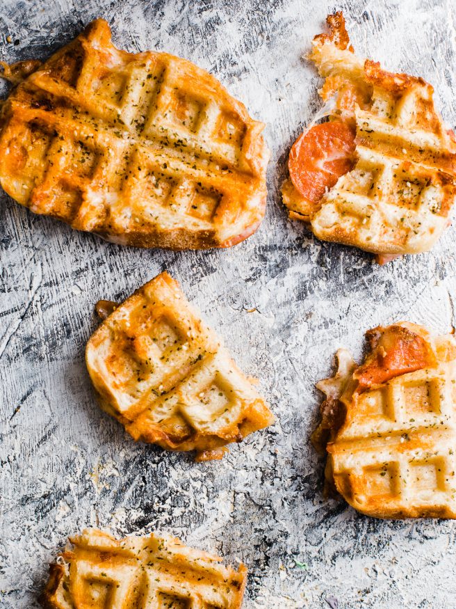 Pepperoni Pizza meets grilled cheese, meets waffle Iron making the best concoction known to man: Pepperoni Pizza Waffle Sandwich!