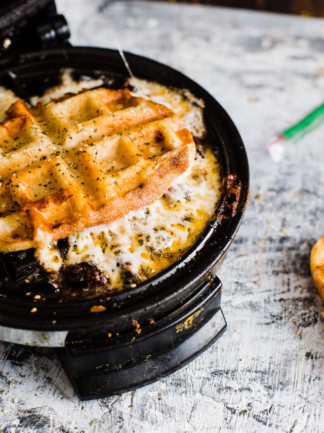 Pepperoni Pizza meets grilled cheese, meets waffle Iron making the best concoction known to man: Pepperoni Pizza Waffle Sandwich!