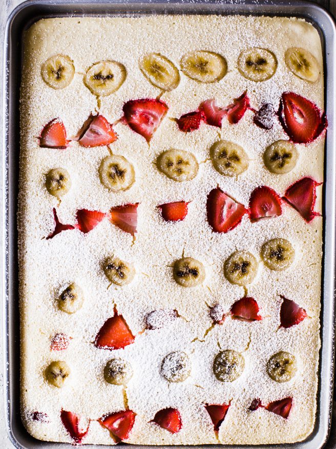 Sheet Pan Pancakes makes breakfast prep extremely easy. Adding fresh fruit on top of your pancakes in a sheet pan, to serve the whole family, or store in meal prep containers for the week! 