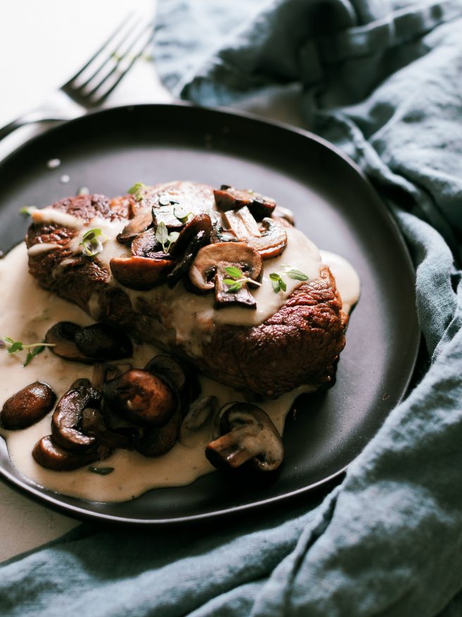 Pan seared filet mignon with a from scratch mushroom cream sauce pour on top. Served with sauteed mushrooms making for an amazing dinner!