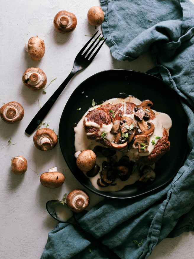 Pan seared filet mignon with a from scratch mushroom cream sauce pour on top. Served with sauteed mushrooms making for an amazing dinner!