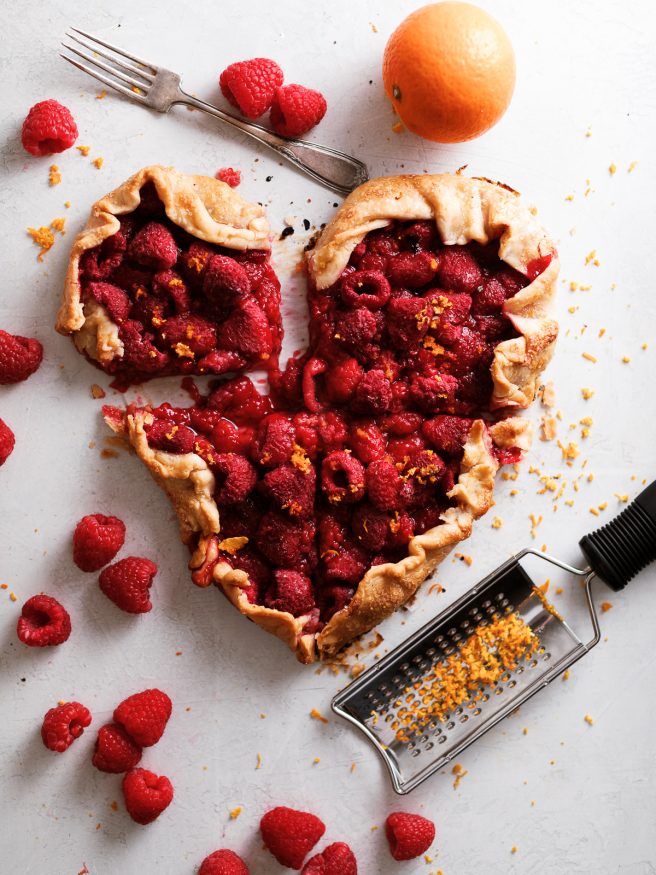 A raspberry galette in the shape of a heart. With raspberries, orange zest and a pre-made pie crust this makes the perfect Valentines Day dessert!