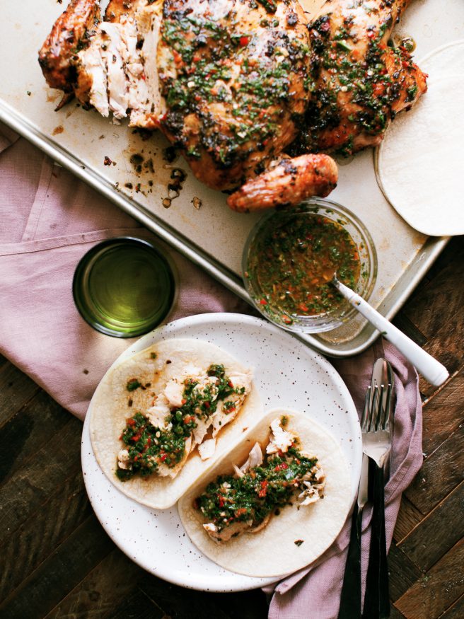 Chimichurri spatchcock chicken cooked on a wood fire grill. Tons of bold, zesty flavors and is a great weekend dinner idea