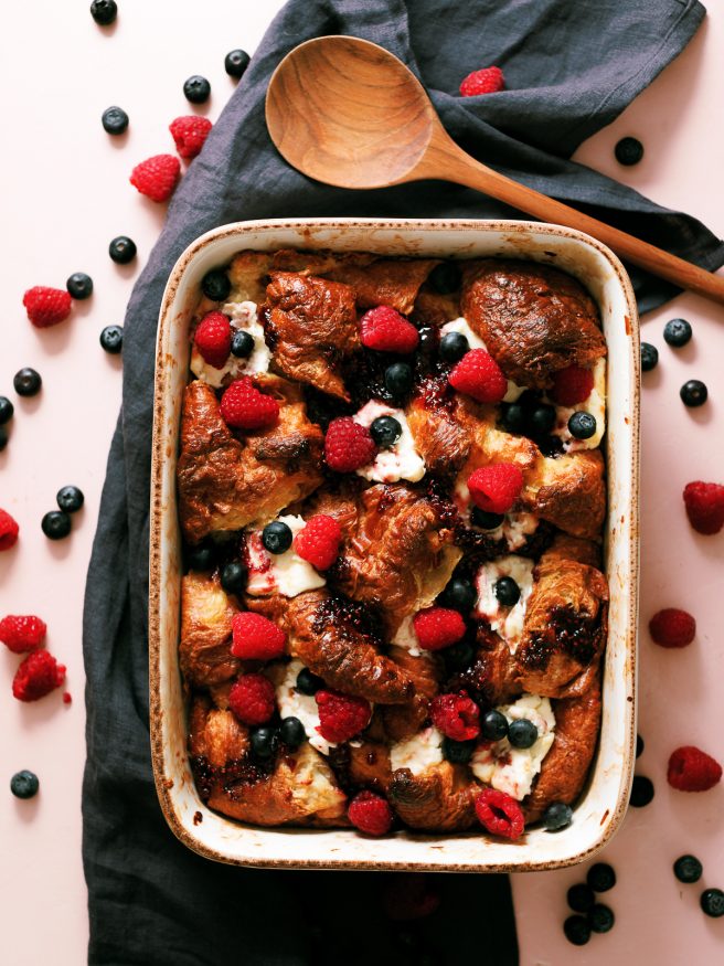 This cream cheese croissant french toast bake is topped with raspberry jam and served with fresh fruit. Can be prepped overnight and bakes in under an hour!