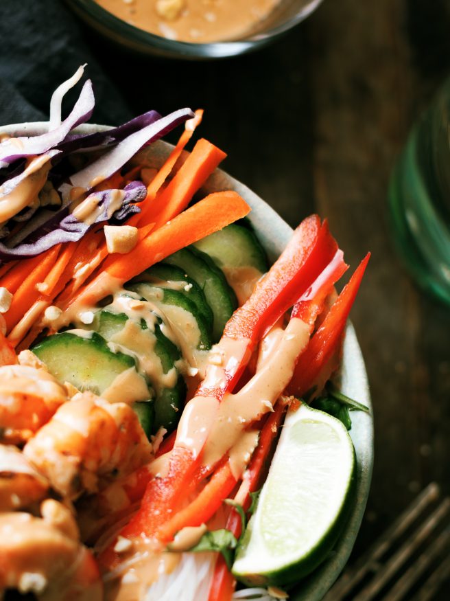 This spring roll bowl has grilled shrimp, rice stick noodles, and fresh veggies topped with a peanut sauce. Much easier to make than actual spring rolls!