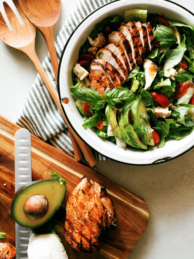 Grilled chicken caprese salad with balsamic marinaded chicken topped with fresh mozzarella, basil and cherry tomatoes. This is the perfect summer salad!