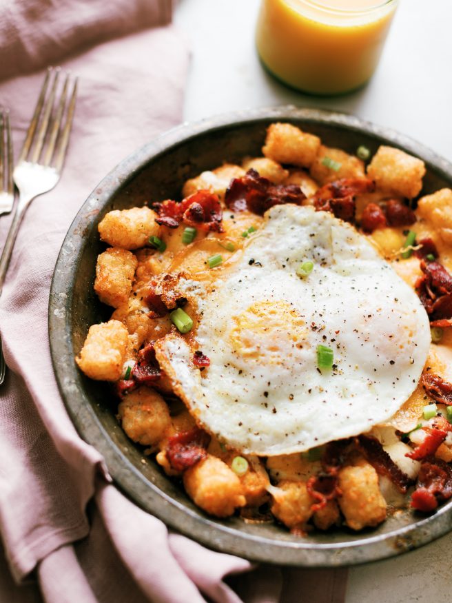 Tater Tots loaded up with bacon, cheese and green onion, then topped with a couple fried eggs. Great breakfast for dinner idea!