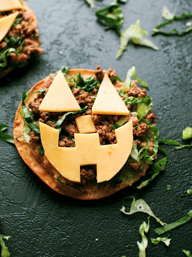  Jack O lantern tostadas are  topped  with beans, taco-seasoned ground beef and cheese cut out into fun jack-o-lantern shapes. Great halloween night dinner!