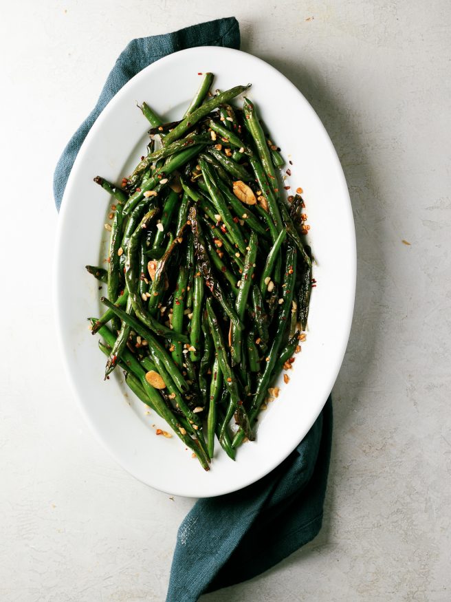 These blistered green beans are fried lightly in oil until blistered, then tossed in a spicy Asian cuisine inspired sauce that is out of this world! 