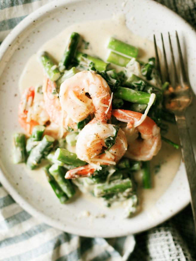 This Keto Shrimp Alfredo is a simple from scratch Alfredo sauce with sauteed shrimp asparagus and spinach. Whats even better is it can double for a pasta as well feeding the carb-lovers in your family all at once! 