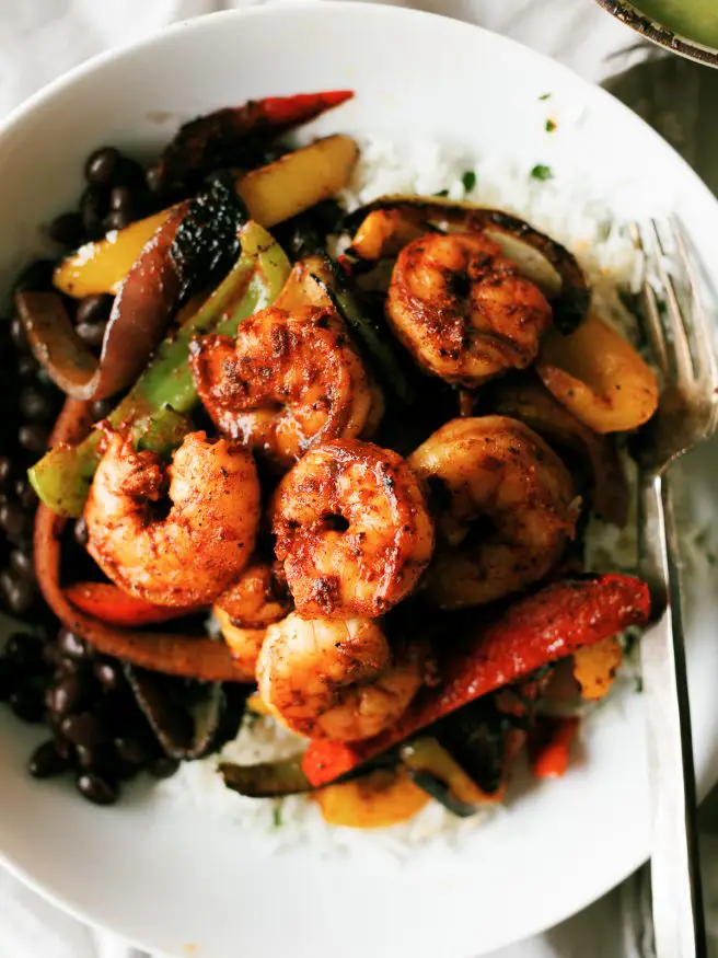 
Shrimp Fajitas on a rice bowl with a little tequila and lime to jazz things up. Topped with an optional spicy avocado crema that will make your taste buds dance!