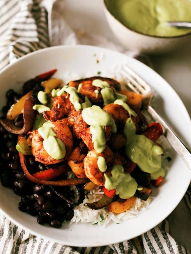 
Shrimp Fajitas on a rice bowl with a little tequila and lime to jazz things up. Topped with an optional spicy avocado crema that will make your taste buds dance!