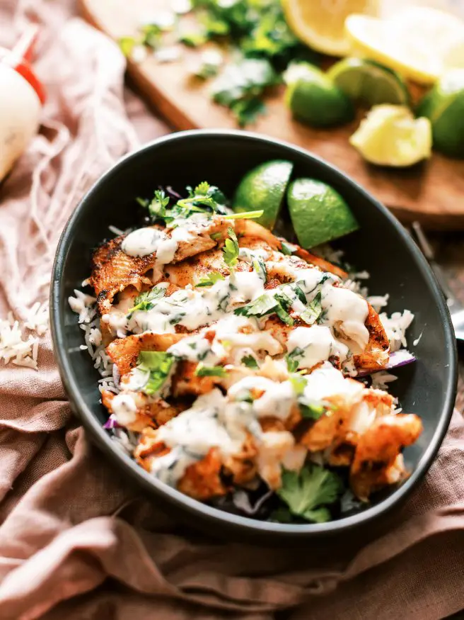 This grilled fish taco bowl is perfect for a weeknight. Beautiful fresh tilapia filets rubbed in a few simple spices, then topped with a cilantro aioli. 