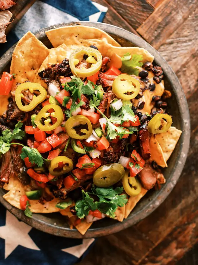 Texas Style Pulled Pork Nachos. Smoked Pulled Pork shoulder on top of cheesy nachos is the best way to spend your weekend.