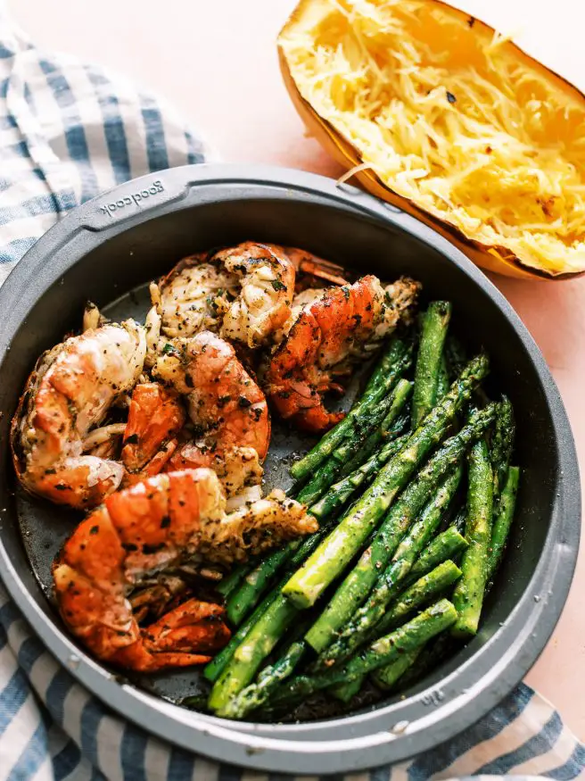 I'm going all out for this recipe and dressing up this spaghetti squash in pesto and topping with some grilled shrimp and asparagus!