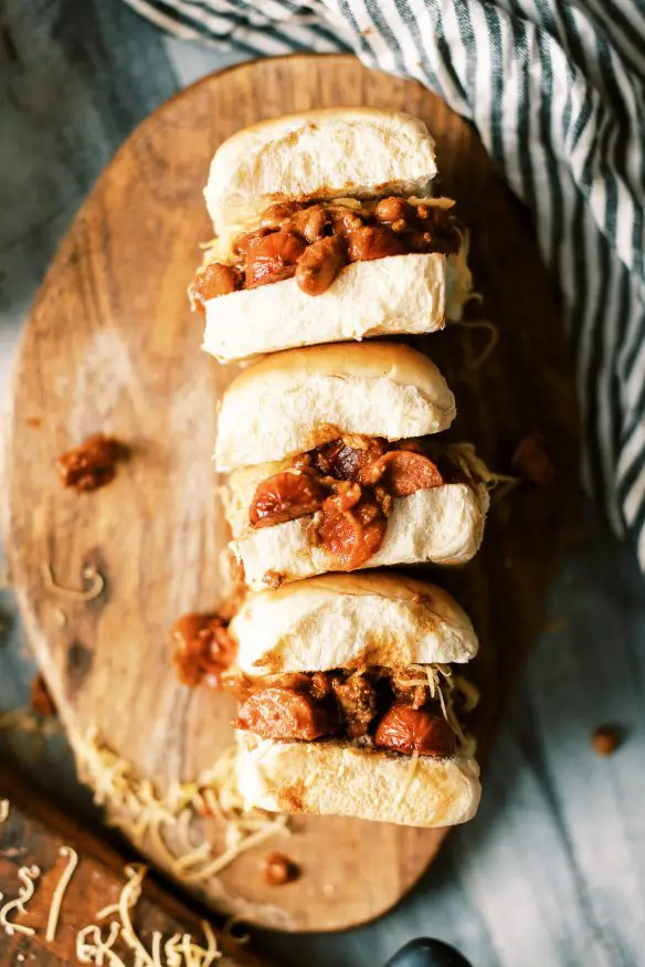 Easy weeknight chili dog sliders with from scratch 30 minute chili recipe. Perfect game day recipe or fun weeknight dinner!
