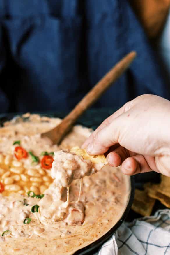 This white bean queso dip is loaded with all sorts of goodness. White Chili Beans , ground beef and all sorts of cheese. It’s got tailgating vibes all over it!  