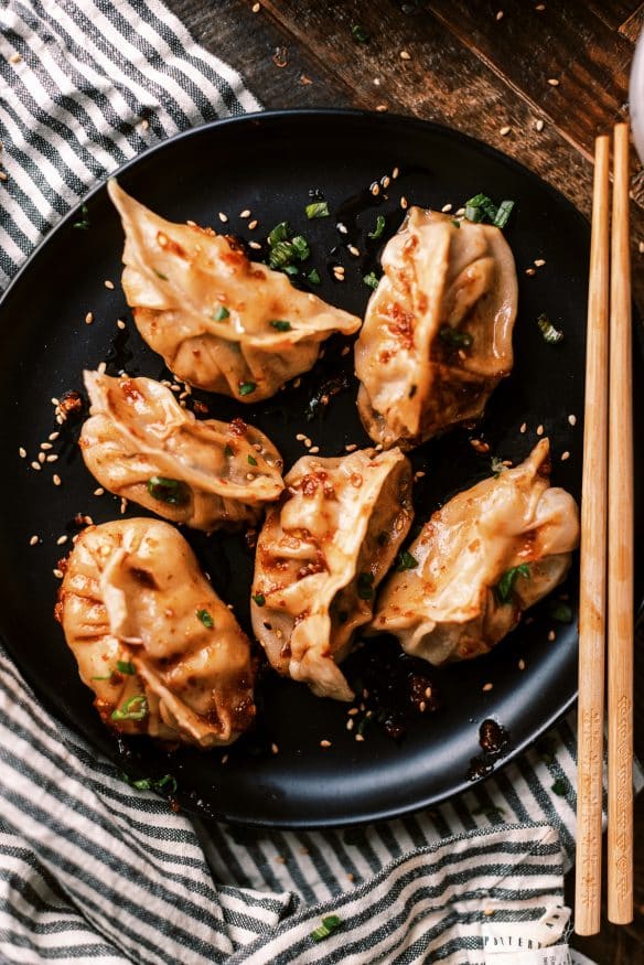 Fried Pork dumplings with a delicious pork filling with ginger, soy sauce rice vinegar, scallions and cabbage and from scratch dough.