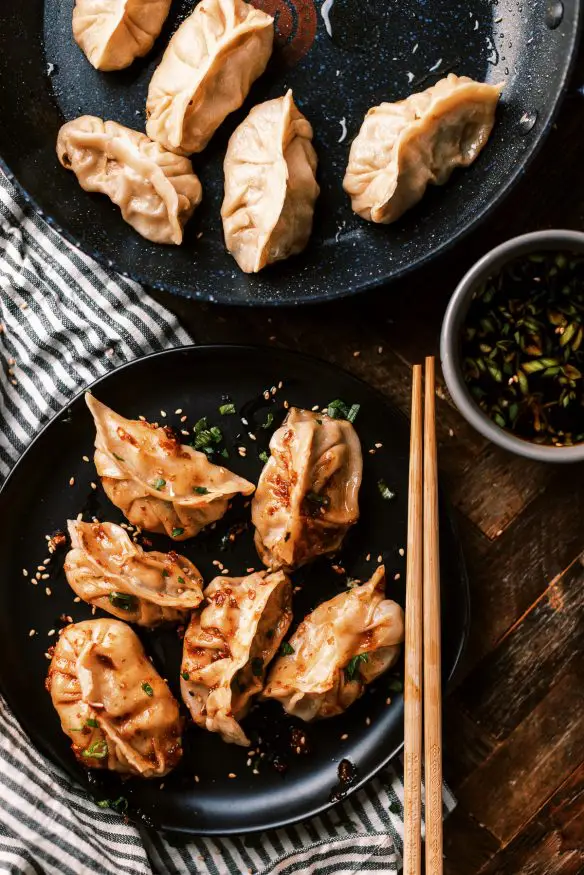 Fried Pork dumplings with a delicious pork filling with ginger, soy sauce rice vinegar, scallions and cabbage and from scratch dough.