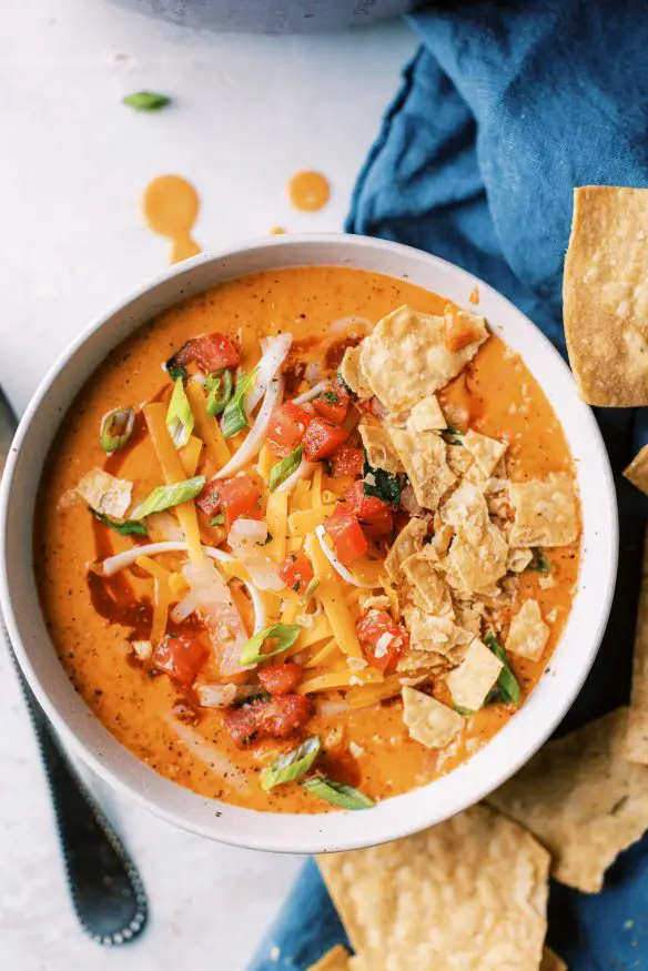 Chicken Enchilada Soup is cheesy, hearty and quite addicting. You can add rotisserie chicken in at the end to make this a quick weekend soup!