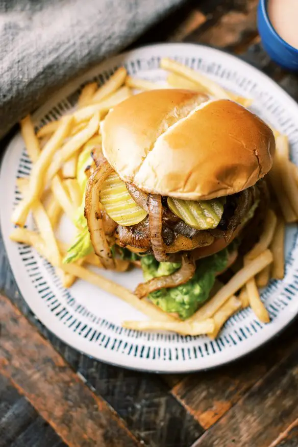 Mustard lined ground chuck, grilled onions and a secret sauce. These are all I need to make the best backyard grilled burger that is sure to be a crowd pleaser. 