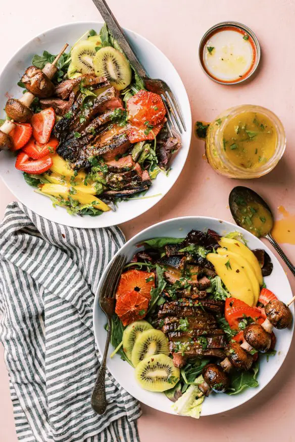 This grilled flank steak summer salad with mango vinaigrette topped with fresh summer fruit for a little sweet, savory and tangy flavors. 