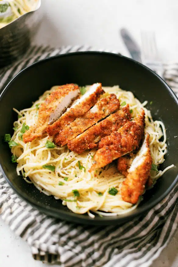 Cacio e pepe with pecorino Romano cheese topped with Italian seasoning breaded chicken cutlets - Italian comfort food at its best!