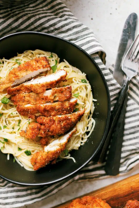 Cacio e pepe with pecorino Romano cheese topped with Italian seasoning breaded chicken cutlets - Italian comfort food at its best!