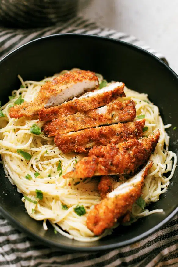 Cacio e pepe with pecorino Romano cheese topped with Italian seasoning breaded chicken cutlets - Italian comfort food at its best!