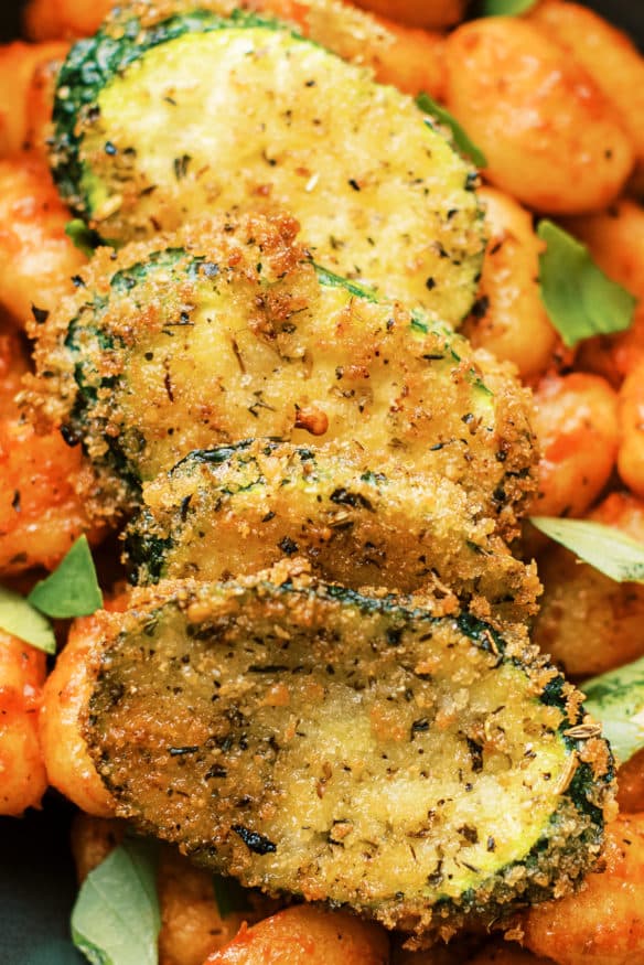 Panko breaded fried zucchini is a great way to inject some veggies into pasta night. Italian seasoned and lightly fried then topped on some gnocchi is perfect!