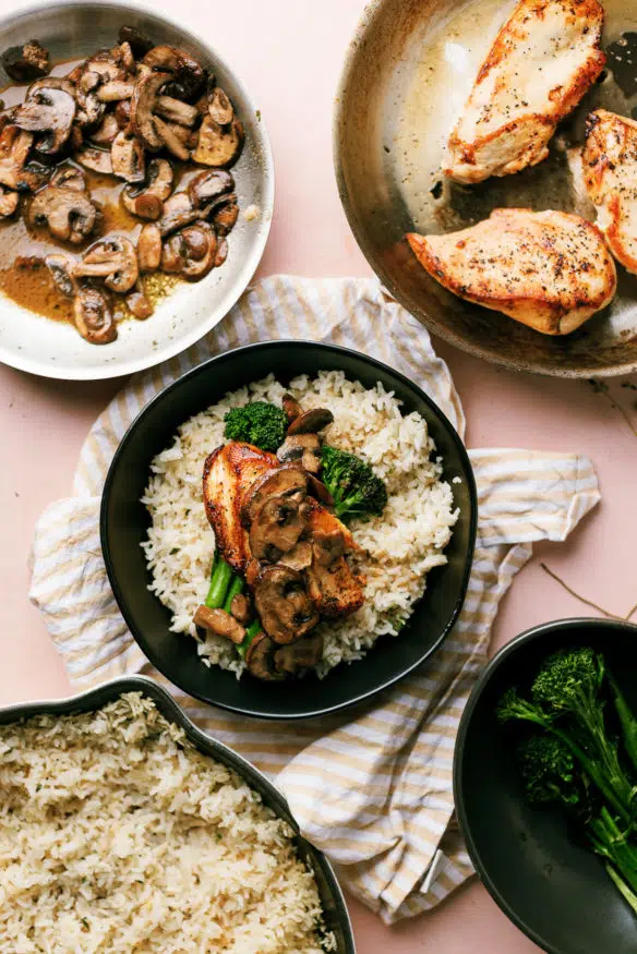 This is the best chicken and rice! Thyme seasoned rice topped with a chicken crusted with black pepper, sauteed mushrooms and broccolini