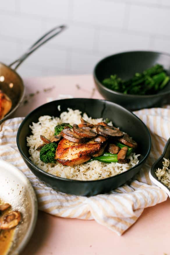 This is the best chicken and rice! Thyme seasoned rice topped with a chicken crusted with black pepper, sauteed mushrooms and broccolini