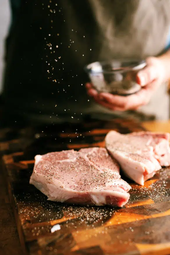 low and slow smoked pork chops topped with a peach glaze that is out of this cooked down with a little bourbon that makes a killer dinner!