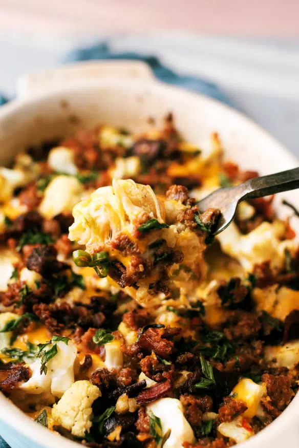 This loaded cauliflower casserole is loaded with cheese, scallions, sausage bacon and serrano peppers and perfect low carb side!