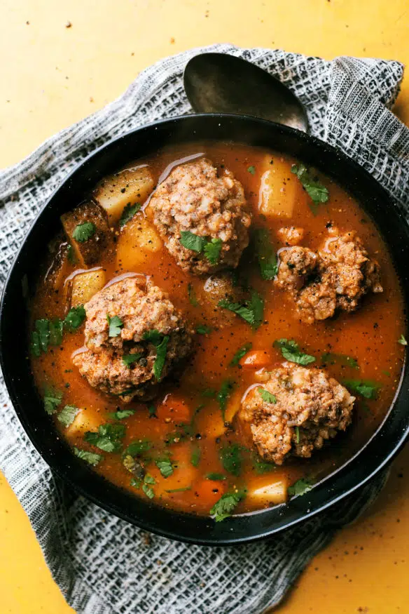 Albondigas is a meatball soup simmered in a tomato base broth flavored with a little cilantro. Kind of reminds me a little of a stew, but the flavor profile is insanely good!