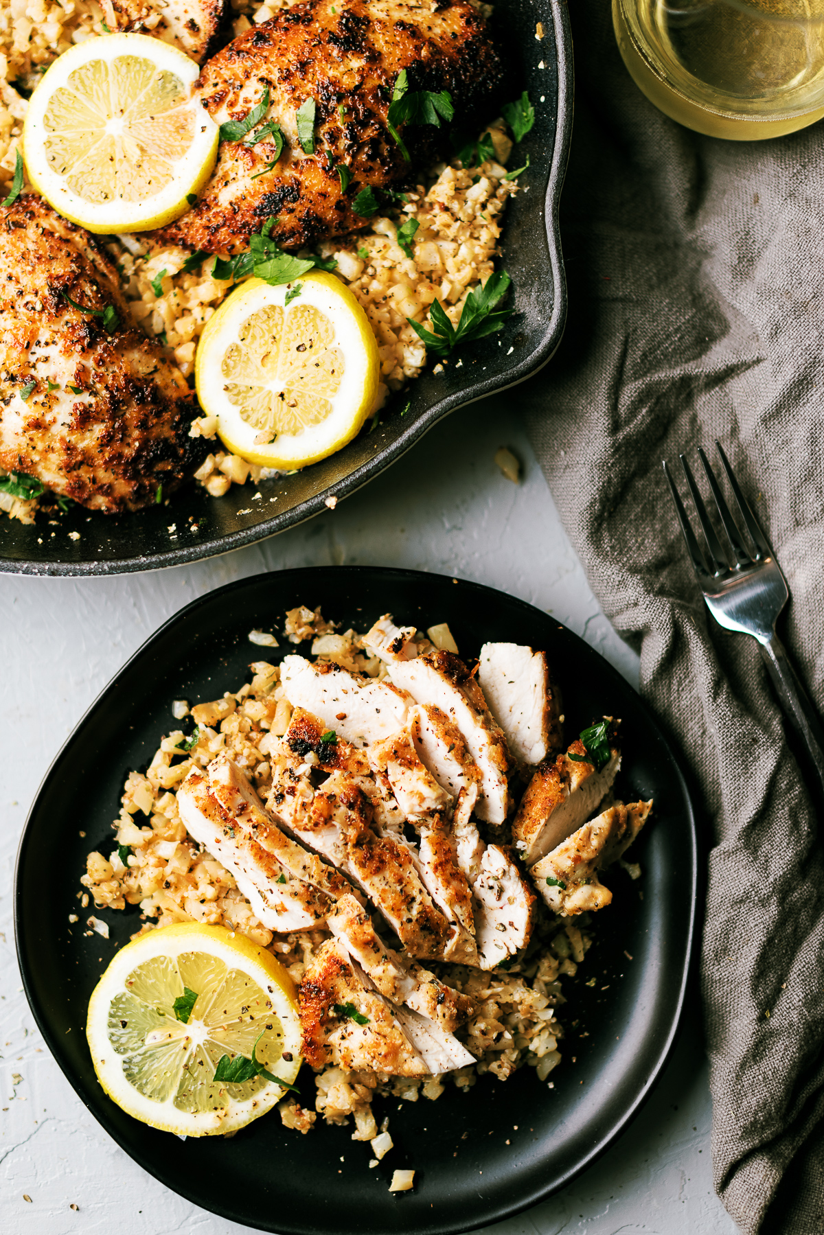 Chicken breast dredged in parmesan and pork rind panko in Italian seasonings sauteed in garlic and butter, topped on some cauliflower rice with some Italian parsley to finish.  