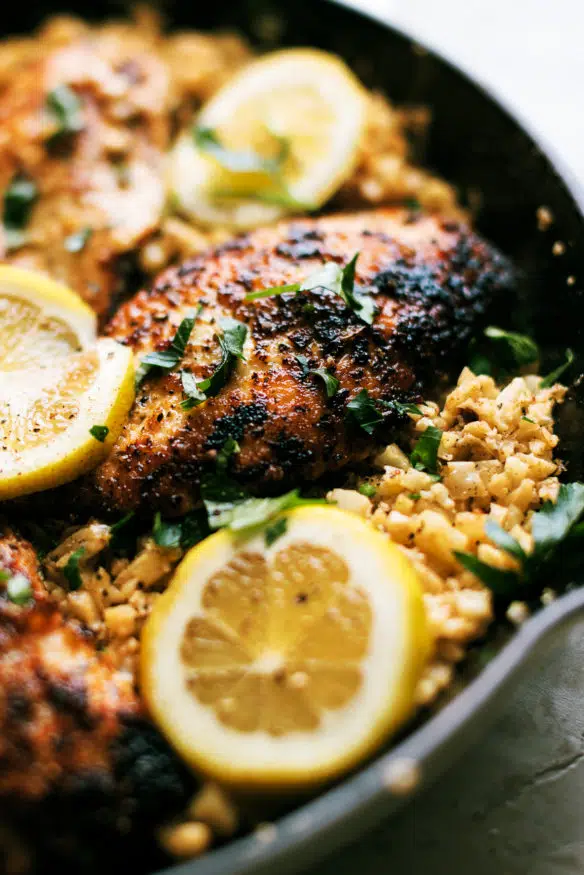 Chicken breast dredged in parmesan and pork rind panko in Italian seasonings sauteed in garlic and butter, topped on some cauliflower rice with some Italian parsley to finish.  