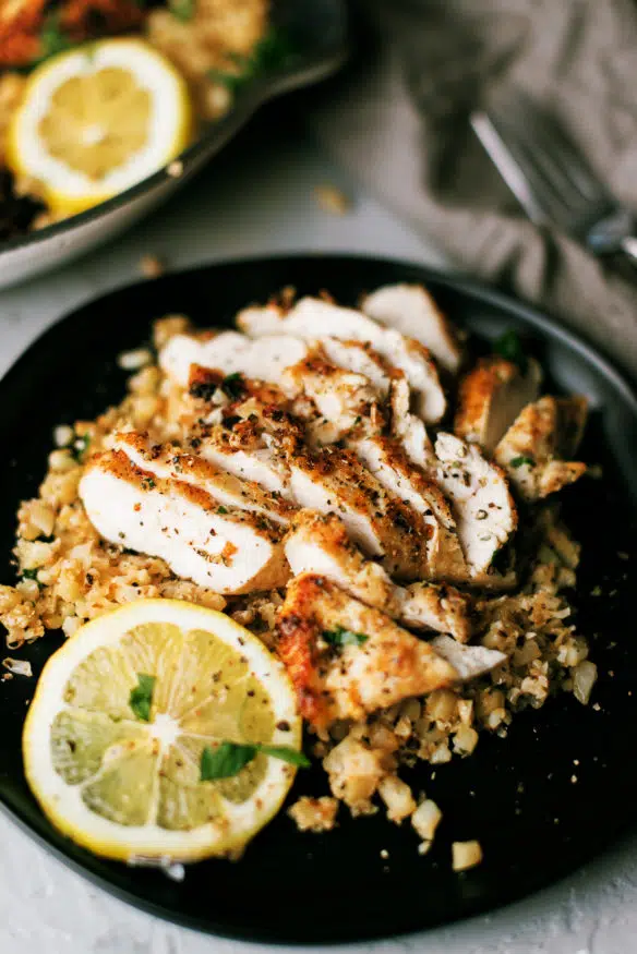 Chicken breast dredged in parmesan and pork rind panko in Italian seasonings sauteed in garlic and butter, topped on some cauliflower rice with some Italian parsley to finish.  