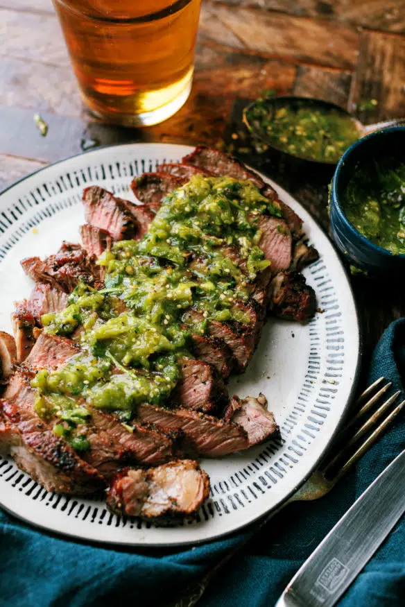 This grilled Ribeye steak is smothered with a spicy and zesty hatch chili verde sauce. It's the perfect combo heading into grilling season!