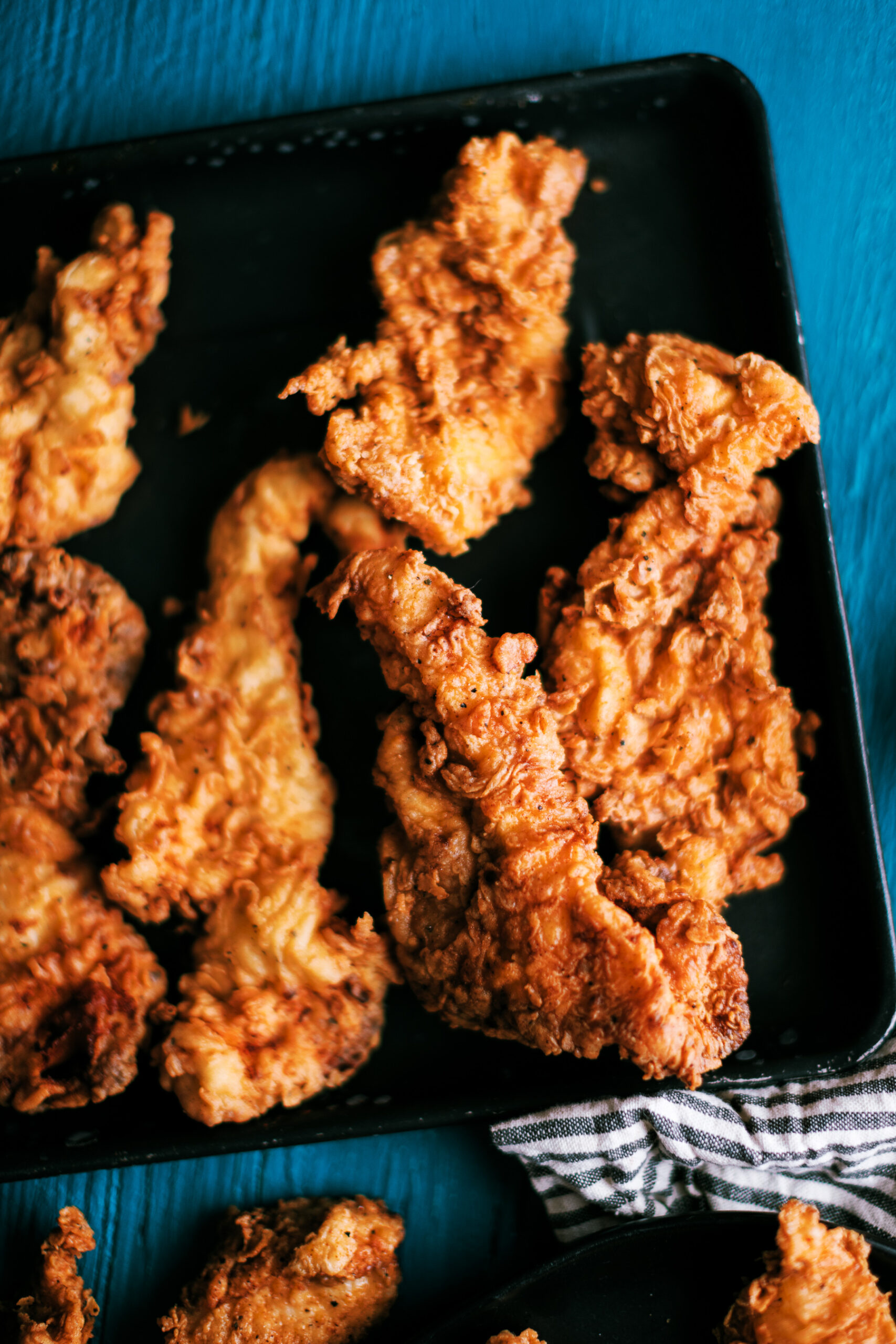 These chicken tenders are marinaded overnight in buttermilk, then dipped in a flour dredge with Cajun seasonings, and fried to perfection.