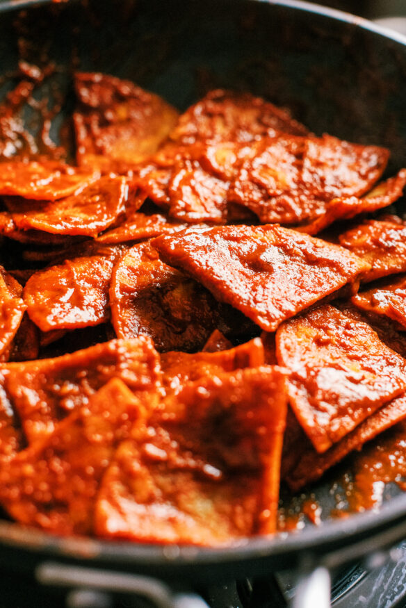 Chilaquiles is a Fried Tortillas with a from scratch guajillo and ancho pepper red sauce, topped with an egg and garnishes.